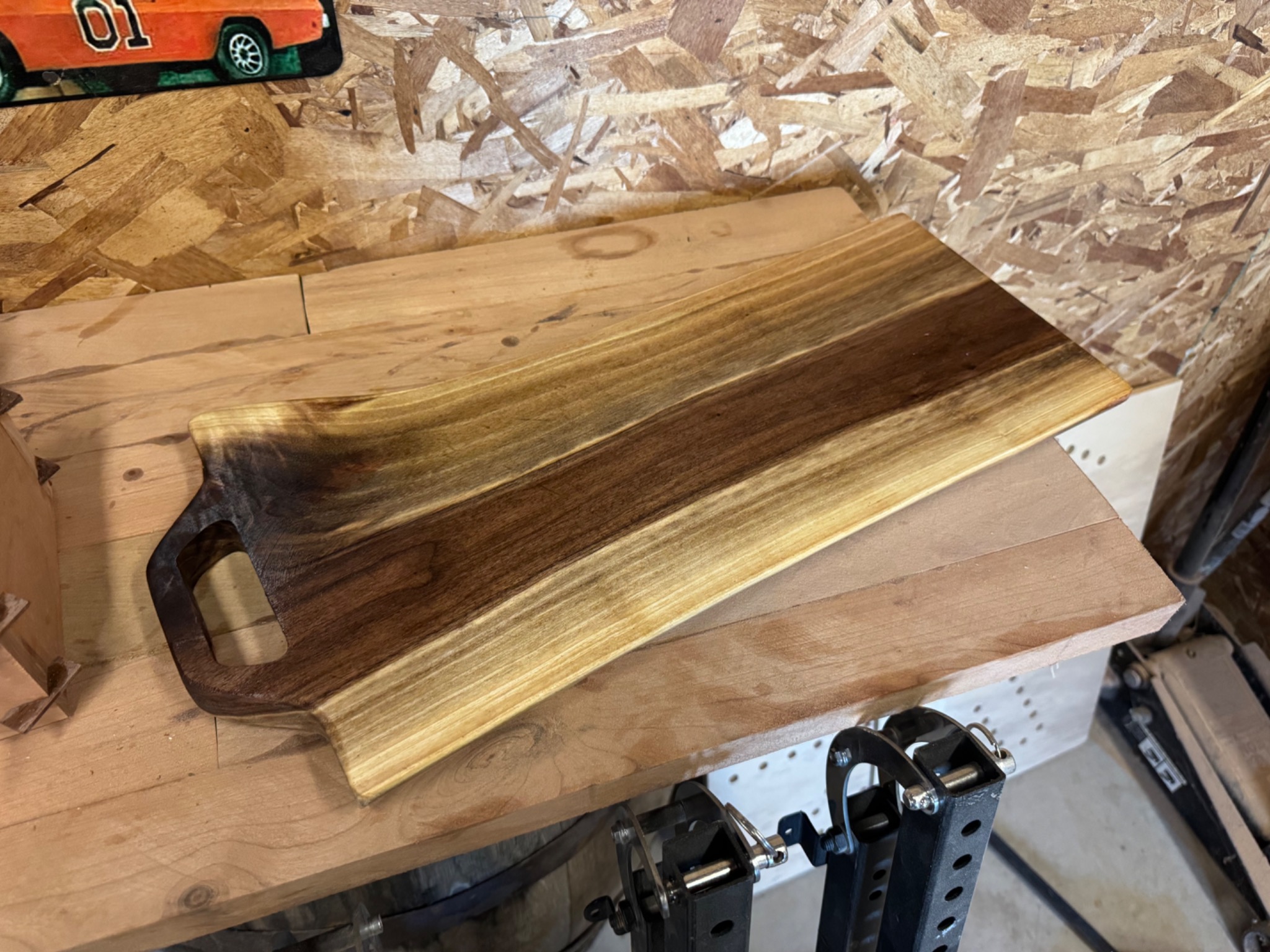 Long live-edge charcuterie board with contrasting dark and golden wood grain