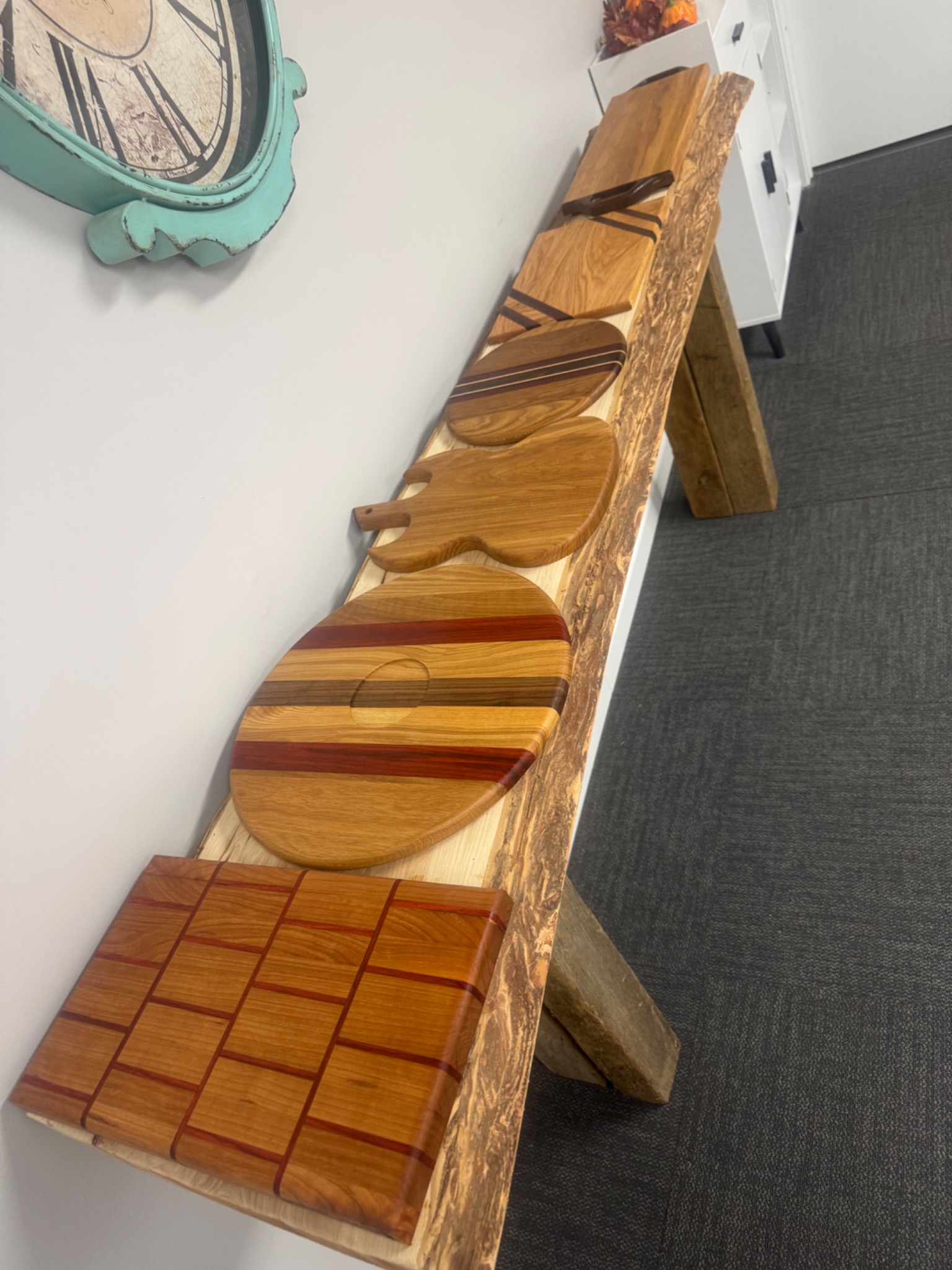 Collection of handcrafted wooden cutting and serving boards in varied shapes and wood patterns