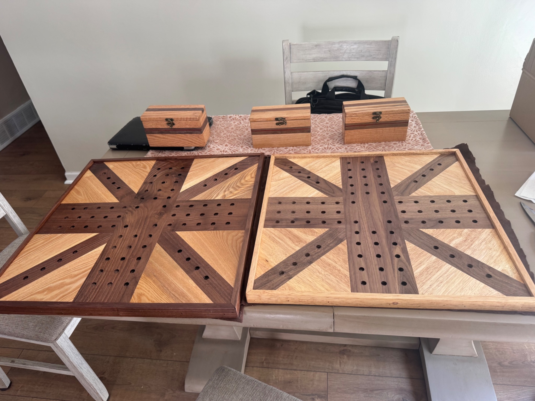 Wooden cribbage board with a matching striped wooden box resting on top