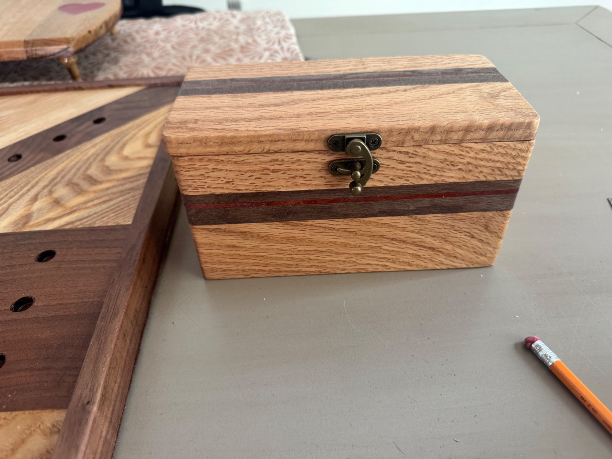 Two handcrafted wooden cribbage boards displayed with three matching storage boxes