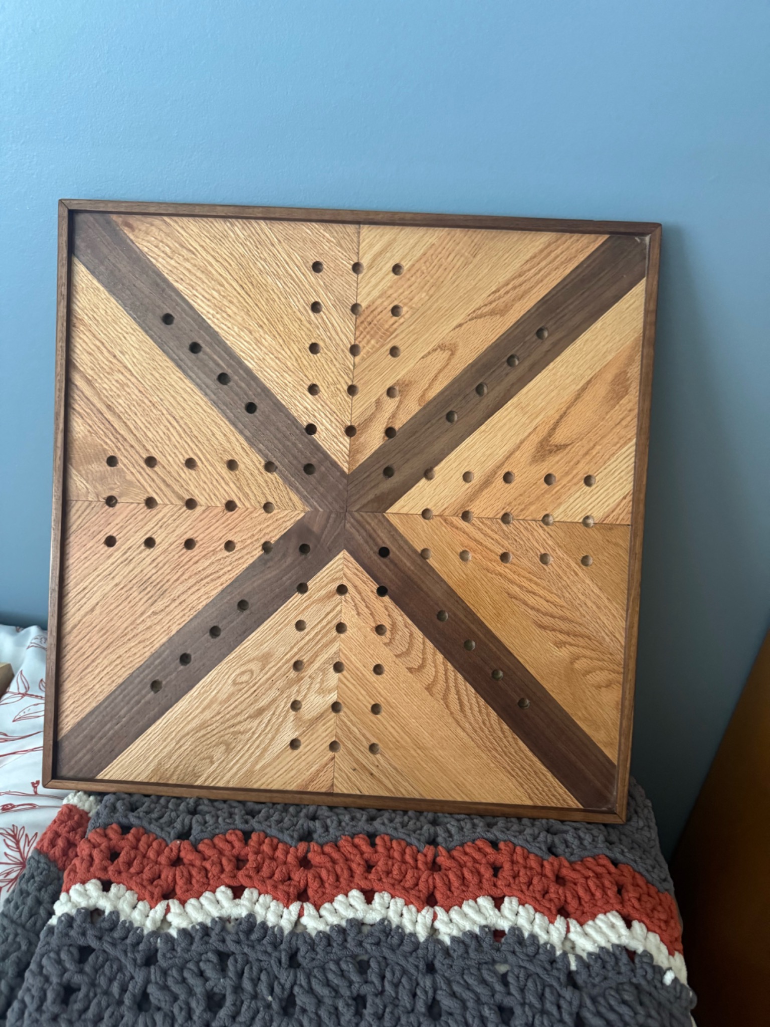 Open handcrafted wooden storage box showing its interior and divider